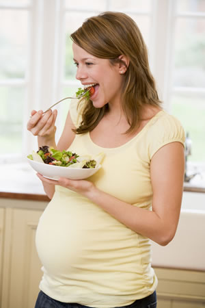 Pregnant woman eating a salad