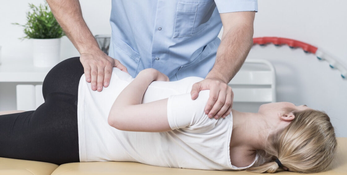 Chiropractor adjusting a woman's hip